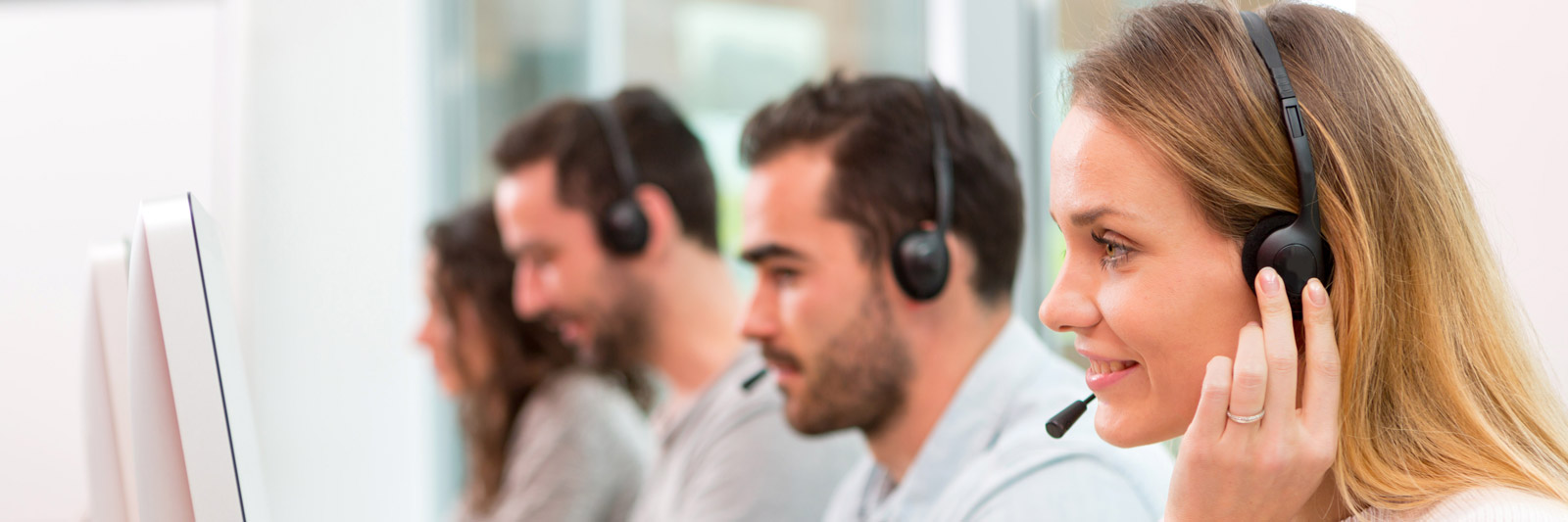 a group of young sales representatives with headsets