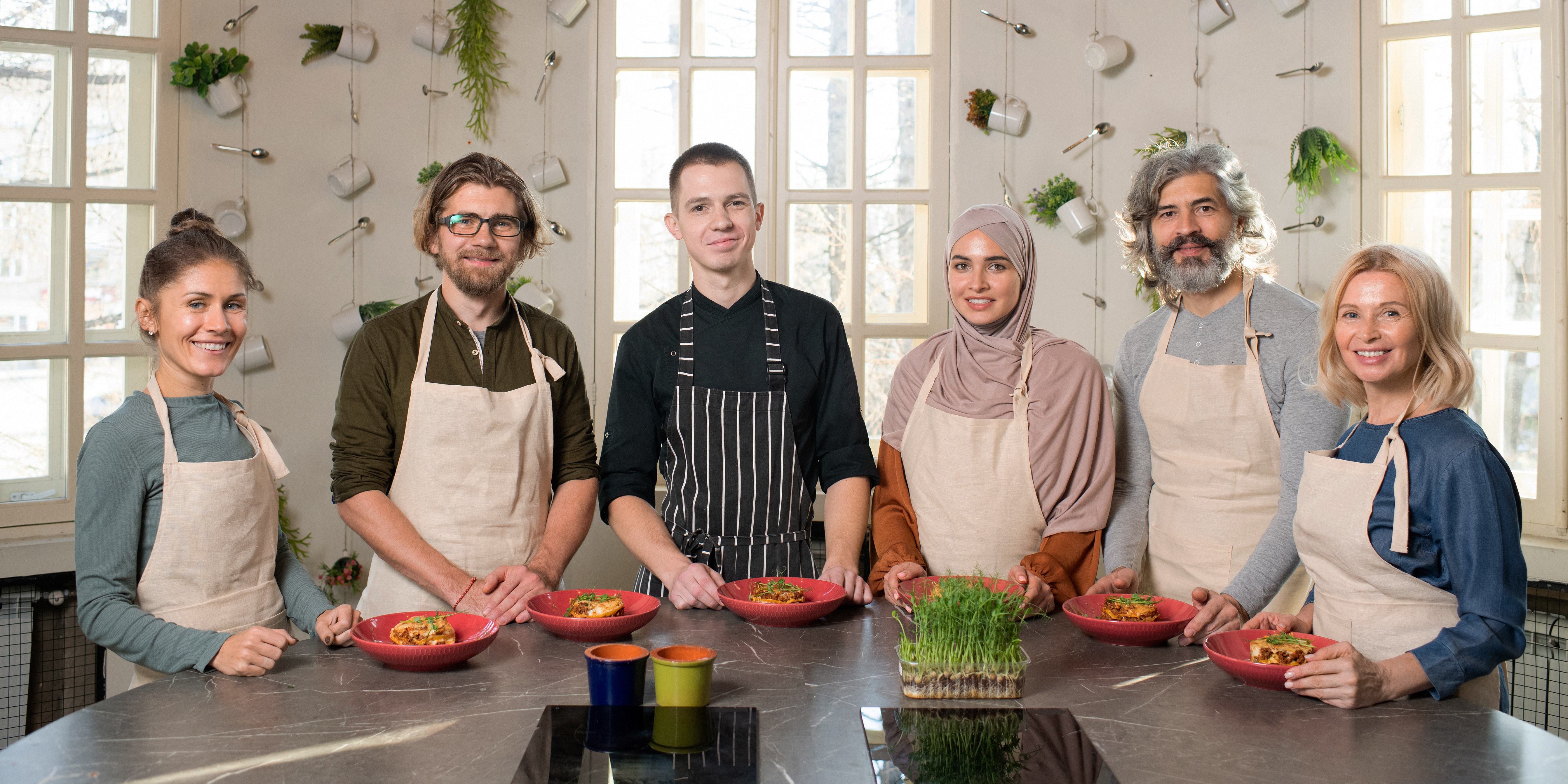 Group of catering apprentices displaying their dishes