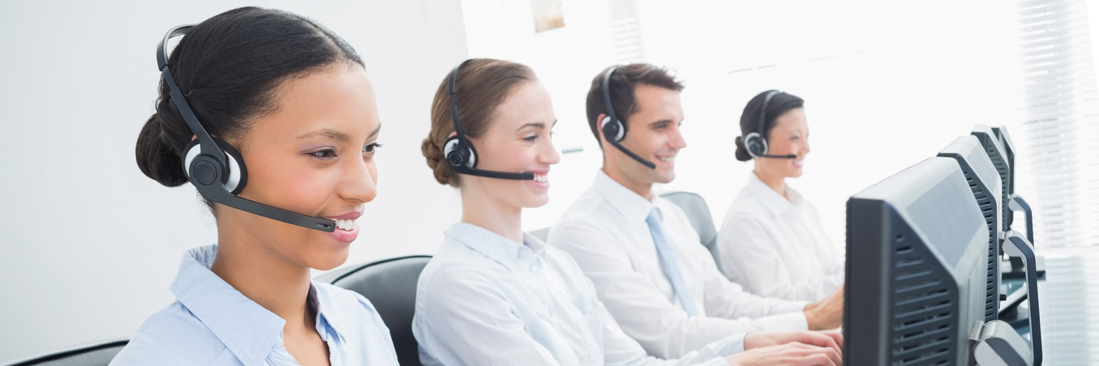 a group of young customer service representatives with headsets