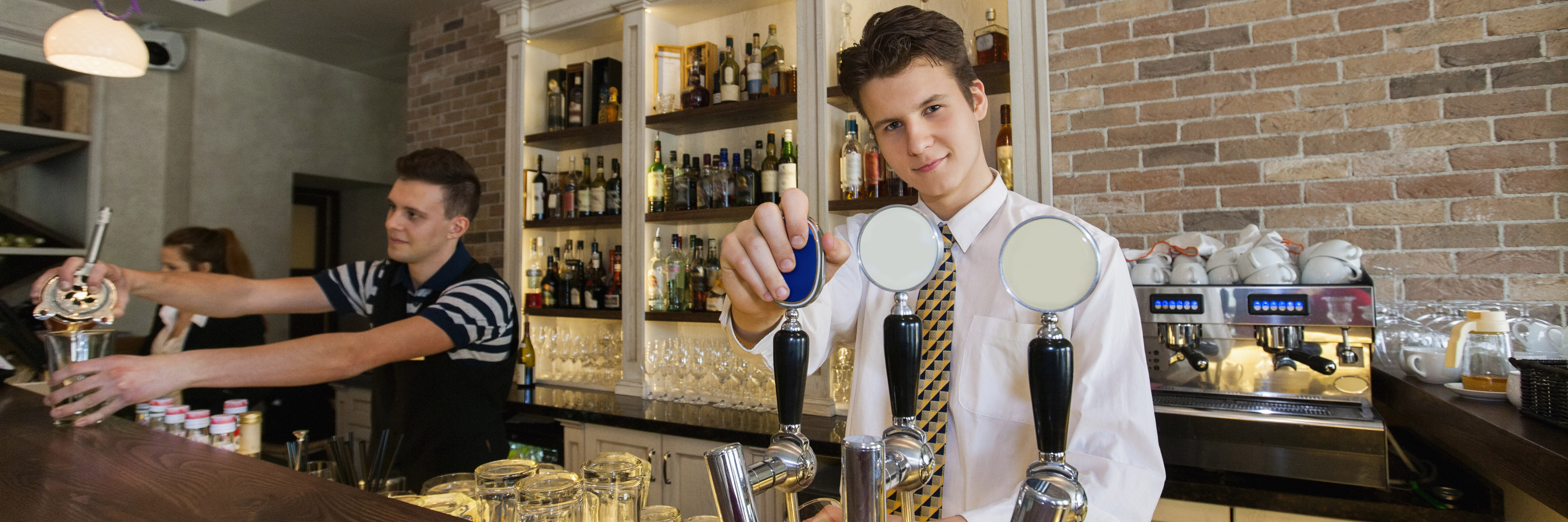 Apprentice serving a drink at a bar
