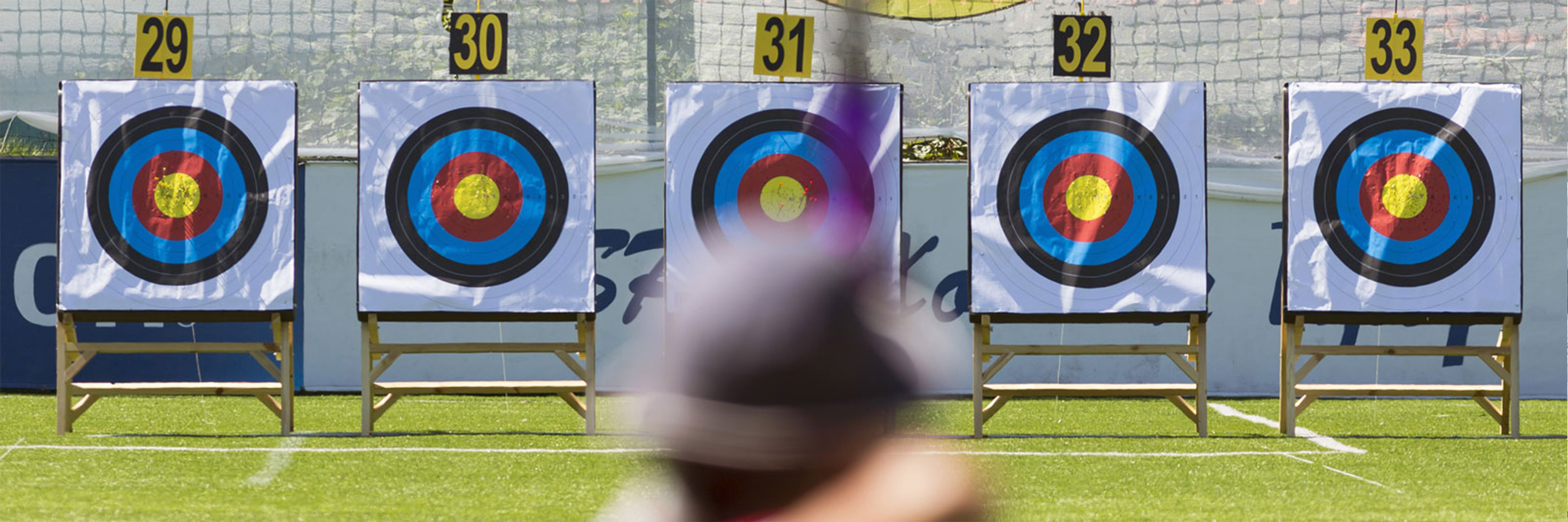 an archer aiming at a set of targets