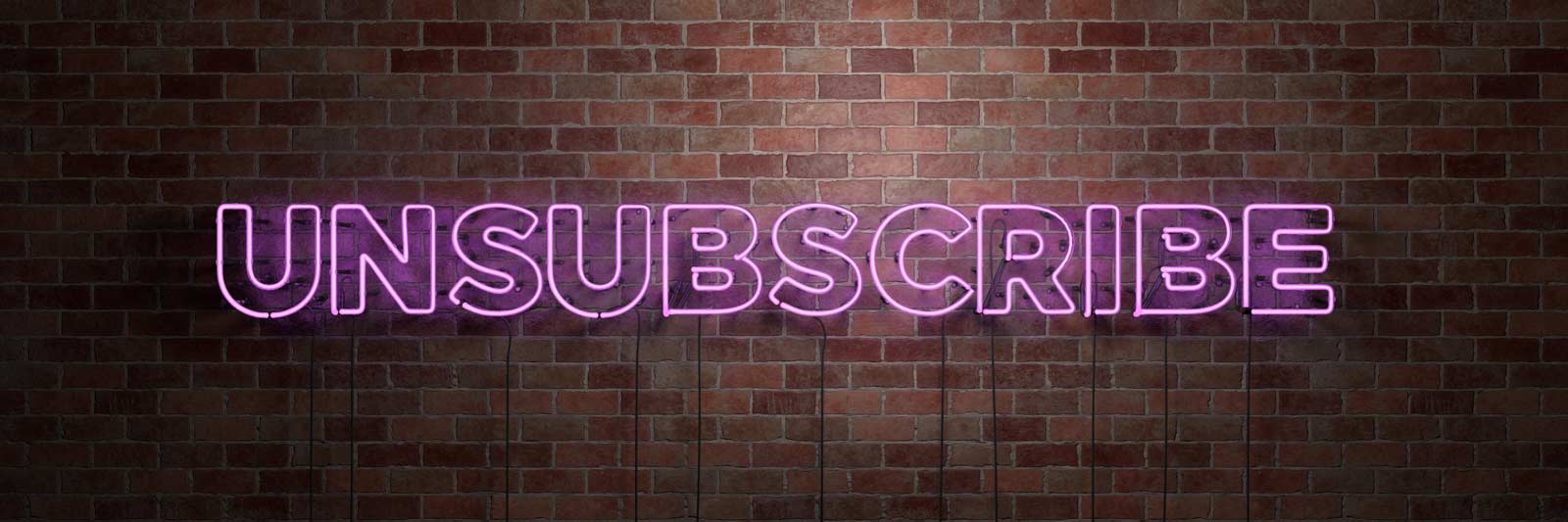 the words unsubscribe in neon lights on a brick wall